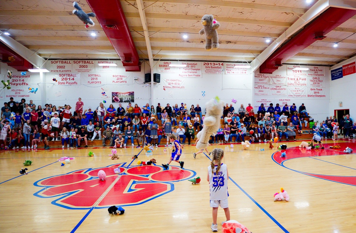 Between the girls and boys games, the Alba-Golden Youth Foundation collection of Toys for Tots saw a slew of stuffed animals and other fluffy, fun characters tossed onto the court. [see more shots, buy basketball photos]
